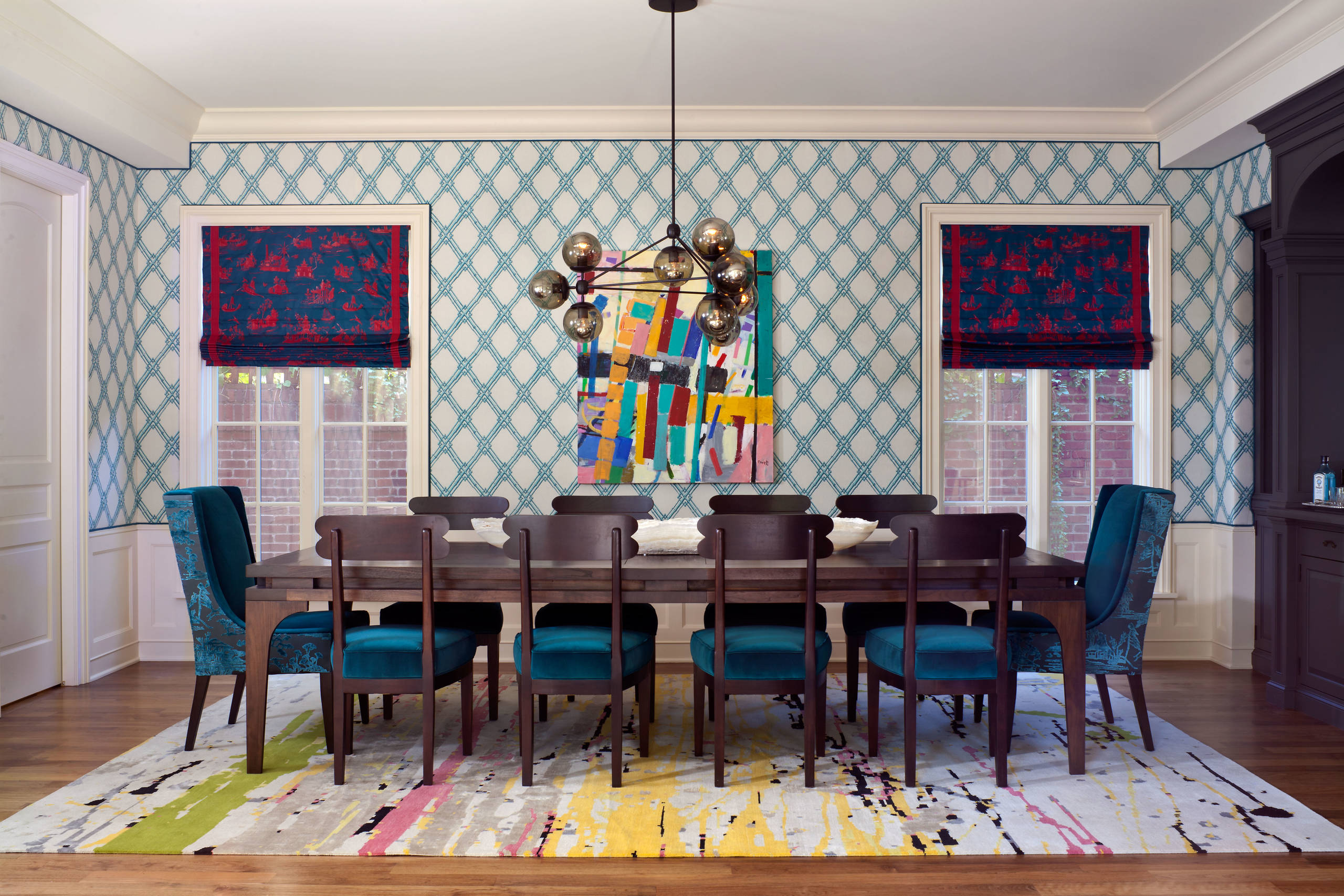 Design ideas for an eclectic enclosed dining room in Denver with multicolored walls and dark hardwood floors