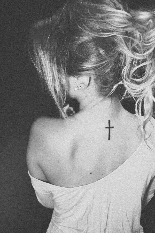 black cross tattoo on back of neck