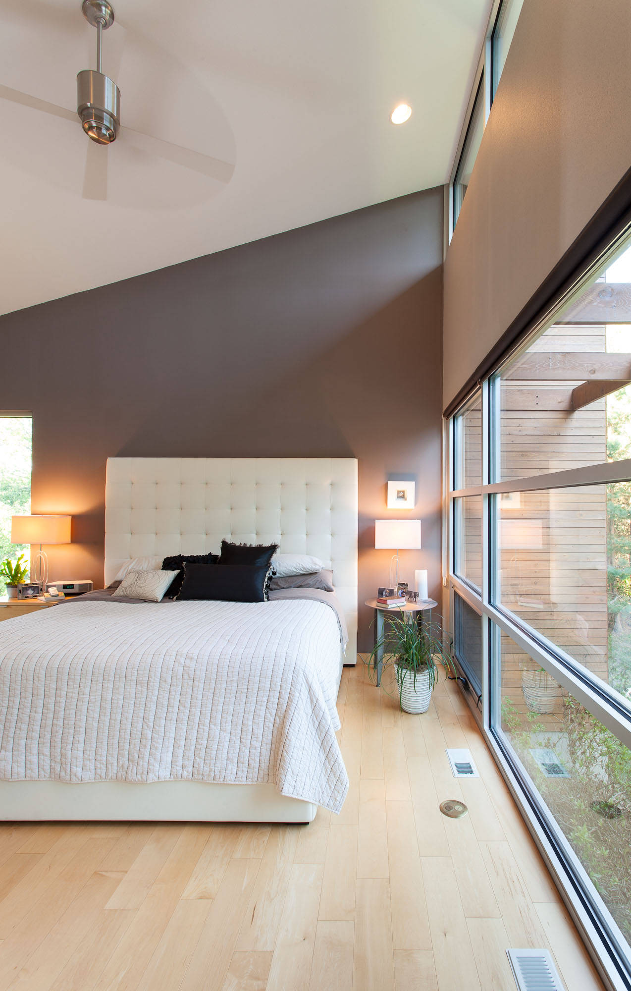 Inspiration for a modern bedroom in Milwaukee with gray walls and light hardwood floors