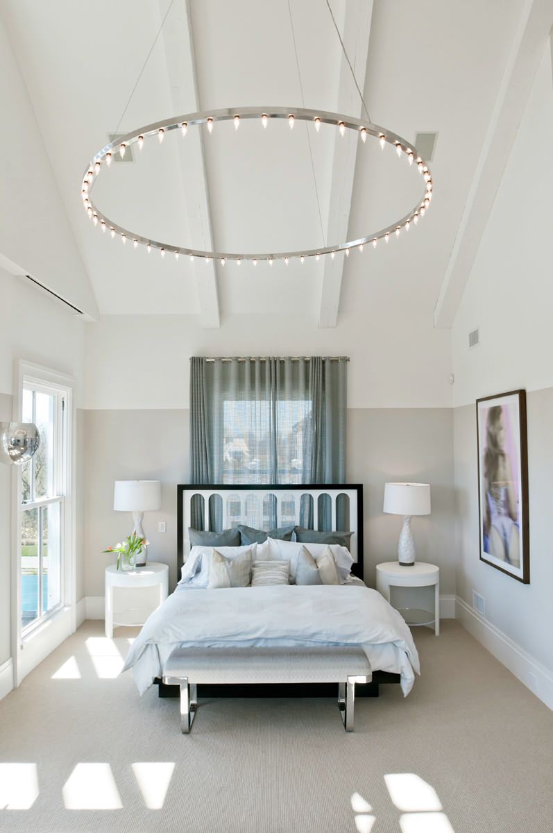 beach style master bedroom in New York with beige walls and carpet