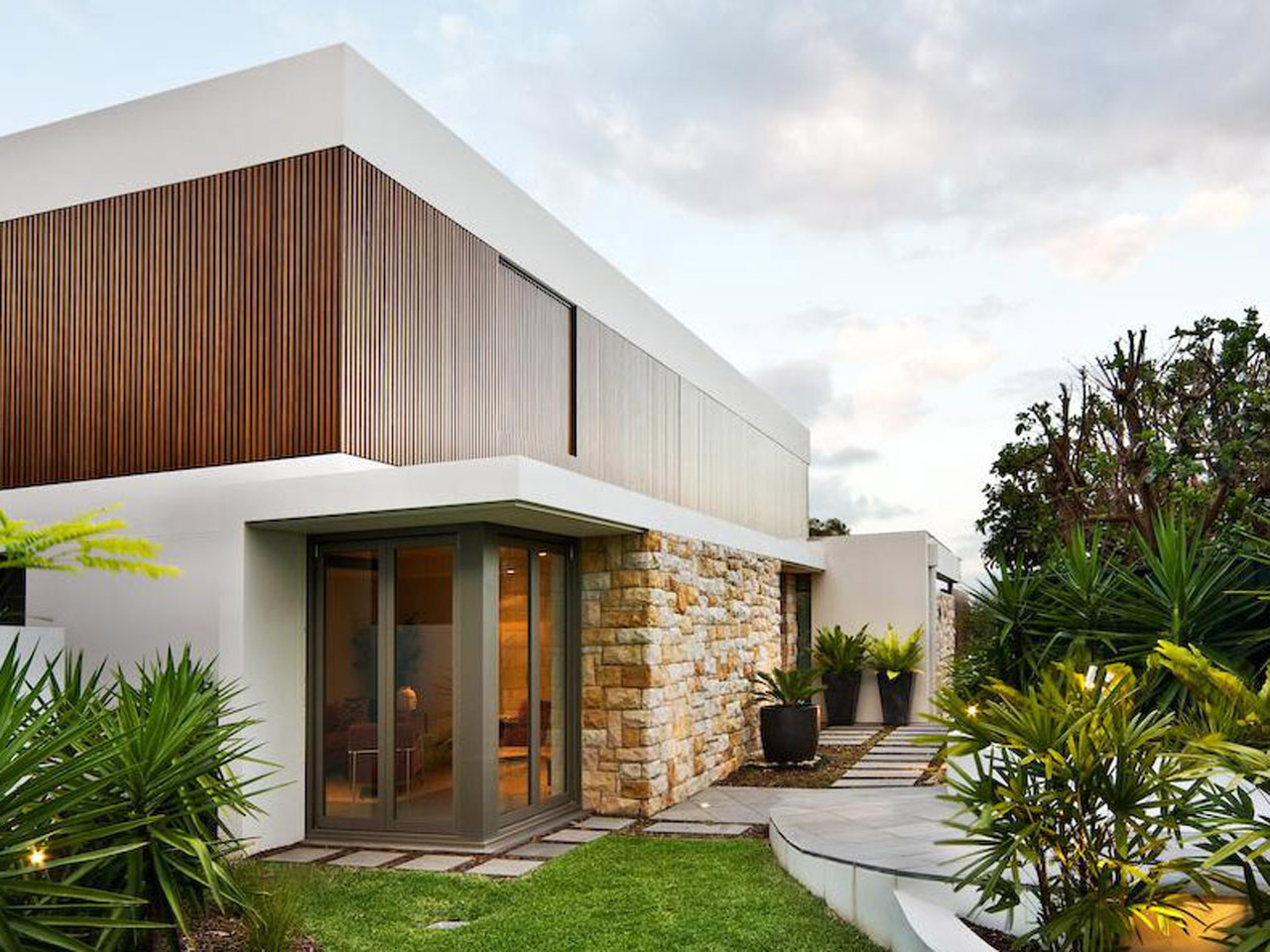 minimalist style home with wood glass stone exterior design
